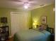 Green bedroom featuring a cozy bed, closet, and a ceiling fan providing optimal comfort at 14 Striding Ridge Ct, Durham, NC 27713