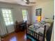 Bright bedroom with hardwood floors, multiple windows, and comfortable furnishings at 14 Striding Ridge Ct, Durham, NC 27713