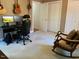 Comfortable bedroom with carpet, featuring a closet, guitars on the wall, and rocking chair at 14 Striding Ridge Ct, Durham, NC 27713