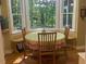 Cozy breakfast nook featuring a round table and bay window with scenic outdoor views at 14 Striding Ridge Ct, Durham, NC 27713