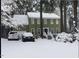 Charming two-story home with a traditional design is beautifully covered in fresh snow at 14 Striding Ridge Ct, Durham, NC 27713