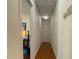 Hallway with hardwood floors and a view into a bedroom with green walls at 14 Striding Ridge Ct, Durham, NC 27713
