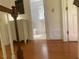 Hallway with hardwood floors leading to a bathroom, showcasing clean lines and neutral tones at 14 Striding Ridge Ct, Durham, NC 27713
