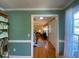 Hallway with hardwood floors leading to a living room and featuring neutral wall colors at 14 Striding Ridge Ct, Durham, NC 27713