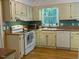 Kitchen with white cabinetry, stainless steel appliances, and hardwood floors at 14 Striding Ridge Ct, Durham, NC 27713