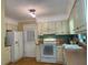 Functional kitchen with white appliances, ample cabinet space, and a bright, airy feel at 14 Striding Ridge Ct, Durham, NC 27713