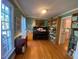 Cozy living room featuring beautiful hardwood floors, a piano, and built-in bookshelves, offering a warm atmosphere at 14 Striding Ridge Ct, Durham, NC 27713