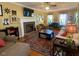 Cozy living room featuring fireplace, TV, sofa and a ceiling fan at 14 Striding Ridge Ct, Durham, NC 27713