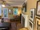 Bright living room with cozy seating, lots of art and a fireplace at 14 Striding Ridge Ct, Durham, NC 27713