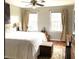 Light-filled main bedroom featuring neutral walls, hardwood floors, and a ceiling fan at 14 Striding Ridge Ct, Durham, NC 27713