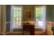 Bright and functional office space featuring built-in desk, dual windows with green paint, and natural light at 14 Striding Ridge Ct, Durham, NC 27713