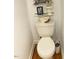Powder room featuring a toilet with decorative shelves above and hardwood floors at 14 Striding Ridge Ct, Durham, NC 27713