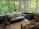 Inviting screened porch with wicker furniture and peaceful views of the surrounding trees at 14 Striding Ridge Ct, Durham, NC 27713