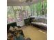 Relaxing screened porch overlooking a lush backyard, furnished with comfortable seating at 14 Striding Ridge Ct, Durham, NC 27713