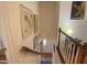 Classic staircase with white railings, wood details, and framed artwork along the walls leading to lower level at 14 Striding Ridge Ct, Durham, NC 27713