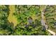Aerial view showcasing the property's location near a serene pond and surrounded by trees at 148 Shadowbrook Dr, Henderson, NC 27537