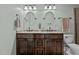 Bathroom featuring double sink, vanity with granite countertop and oval mirrors at 148 Shadowbrook Dr, Henderson, NC 27537