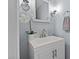 Stylish bathroom sink and vanity illuminated by modern sconces, complemented by a decorative mirror and towel ring at 148 Shadowbrook Dr, Henderson, NC 27537