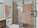 Bathroom featuring glass enclosed shower, tiled walls, and river rock floor at 148 Shadowbrook Dr, Henderson, NC 27537