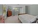 Well-lit bedroom with two windows, neutral carpet, and classic wood furniture at 148 Shadowbrook Dr, Henderson, NC 27537