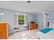 Bedroom featuring a light blue painted walls, carpet floor and a window at 148 Shadowbrook Dr, Henderson, NC 27537