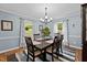 Formal dining area with hardwood floors, a chandelier, and room for six at 148 Shadowbrook Dr, Henderson, NC 27537