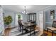 Dining room features a chandelier, cabinet, modern rug, and natural light at 148 Shadowbrook Dr, Henderson, NC 27537