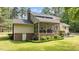 Back exterior view of home with a brick foundation, screened in porch, and well-maintained lawn at 148 Shadowbrook Dr, Henderson, NC 27537