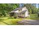 Exterior of home with screened porch, brick foundation, flag pole, and well-maintained lawn at 148 Shadowbrook Dr, Henderson, NC 27537
