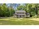 Inviting two-story home with a classic facade, mature trees, and a lush green lawn creating great curb appeal at 148 Shadowbrook Dr, Henderson, NC 27537