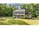 Beautiful home with a covered front porch, classic design and mature trees creating a private, park-like setting at 148 Shadowbrook Dr, Henderson, NC 27537