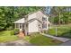 Charming home with a screened porch and an American flag, nestled in a serene and well-manicured landscape at 148 Shadowbrook Dr, Henderson, NC 27537