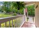 Charming front porch with fern, flag, and lush green landscaping at 148 Shadowbrook Dr, Henderson, NC 27537