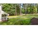 Spacious front lawn with landscaped walkway and mature trees at 148 Shadowbrook Dr, Henderson, NC 27537
