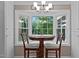 Cozy breakfast nook with bay window providing lots of natural light, cabinets on each side and wood furnishings at 148 Shadowbrook Dr, Henderson, NC 27537