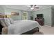 Relaxing main bedroom with neutral carpet, dark wood furnishings, and soft green walls at 148 Shadowbrook Dr, Henderson, NC 27537