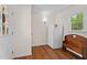 Functional mud room area with wooden bench and a refrigerator, leading to an exterior door at 148 Shadowbrook Dr, Henderson, NC 27537