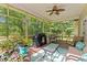 Inviting screened porch with comfortable seating, fan, and peaceful backyard scenery at 148 Shadowbrook Dr, Henderson, NC 27537