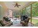 Relaxing screened porch with ceiling fan, outdoor seating, and a view of the backyard at 148 Shadowbrook Dr, Henderson, NC 27537