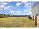 Spacious backyard with a wooden fence and a small wooden deck at 152 Briar Den Ct, Benson, NC 27504