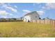 The backyard features a well-maintained lawn surrounded by a wooden fence at 152 Briar Den Ct, Benson, NC 27504
