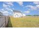 Backyard with ample grass area, framed by a wooden fence for privacy and security at 152 Briar Den Ct, Benson, NC 27504
