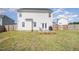 Backyard features a well-maintained lawn and a cozy wooden deck with outdoor seating at 152 Briar Den Ct, Benson, NC 27504