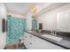 Well-lit bathroom with double sinks, modern fixtures, and a shower with a patterned curtain at 152 Briar Den Ct, Benson, NC 27504