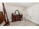 Bedroom boasts a dresser and carpet flooring with a view into an adjacent room at 152 Briar Den Ct, Benson, NC 27504