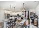 Dining area with white cabinets, stainless steel appliances, and an elegant lighting fixture above the table at 152 Briar Den Ct, Benson, NC 27504