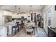 Bright dining area and kitchen with white cabinets, stainless steel appliances, and island seating at 152 Briar Den Ct, Benson, NC 27504