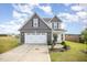 Two-story home with a two-car garage, gray and white siding, well-maintained lawn, and a concrete driveway at 152 Briar Den Ct, Benson, NC 27504