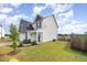 Exterior angle of a two-story home with white siding and a fenced-in backyard and a green lawn at 152 Briar Den Ct, Benson, NC 27504