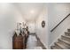 Hallway with light-colored walls, wood-look flooring, leading to stairs and the front door at 152 Briar Den Ct, Benson, NC 27504